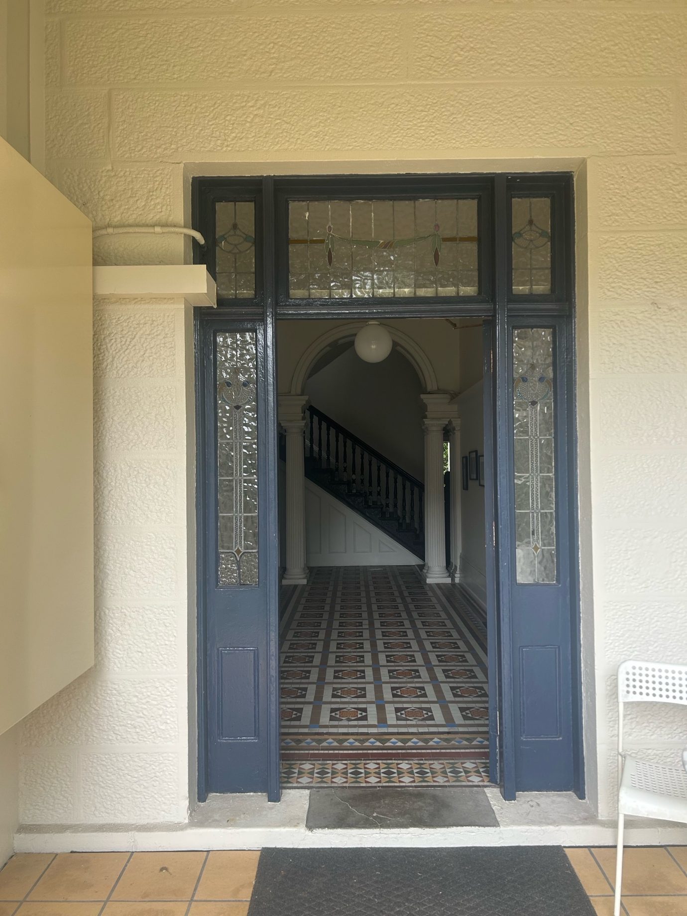 A door with a staircase in the background AI-generated content may be incorrect.